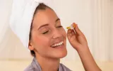 women applying hemp seed oil on face